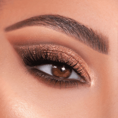 Bronze shimmer eye look showcases Bare Necessities ColourPop Shadow Palette, blending warm matte neutrals with copper glitter on the lid, soft brown crease, and champagne inner-corner highlight, framed by full lashes and a groomed brow.