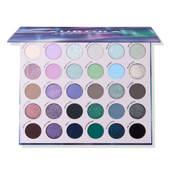 Aurora Struck eyeshadow palette half-closed, showing its iridescent Northern Lights lid
