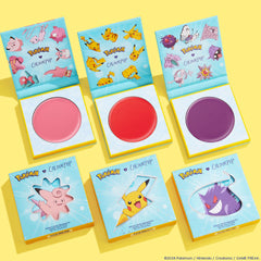 Electrifying Dreams ColourPop Cream Blush set presenting three open pans - soft pink, bright red, and deep purple - inside teal Pokémon-themed compacts, with matching boxes showing Clefairy, Pikachu, and Gengar on a bright yellow background.