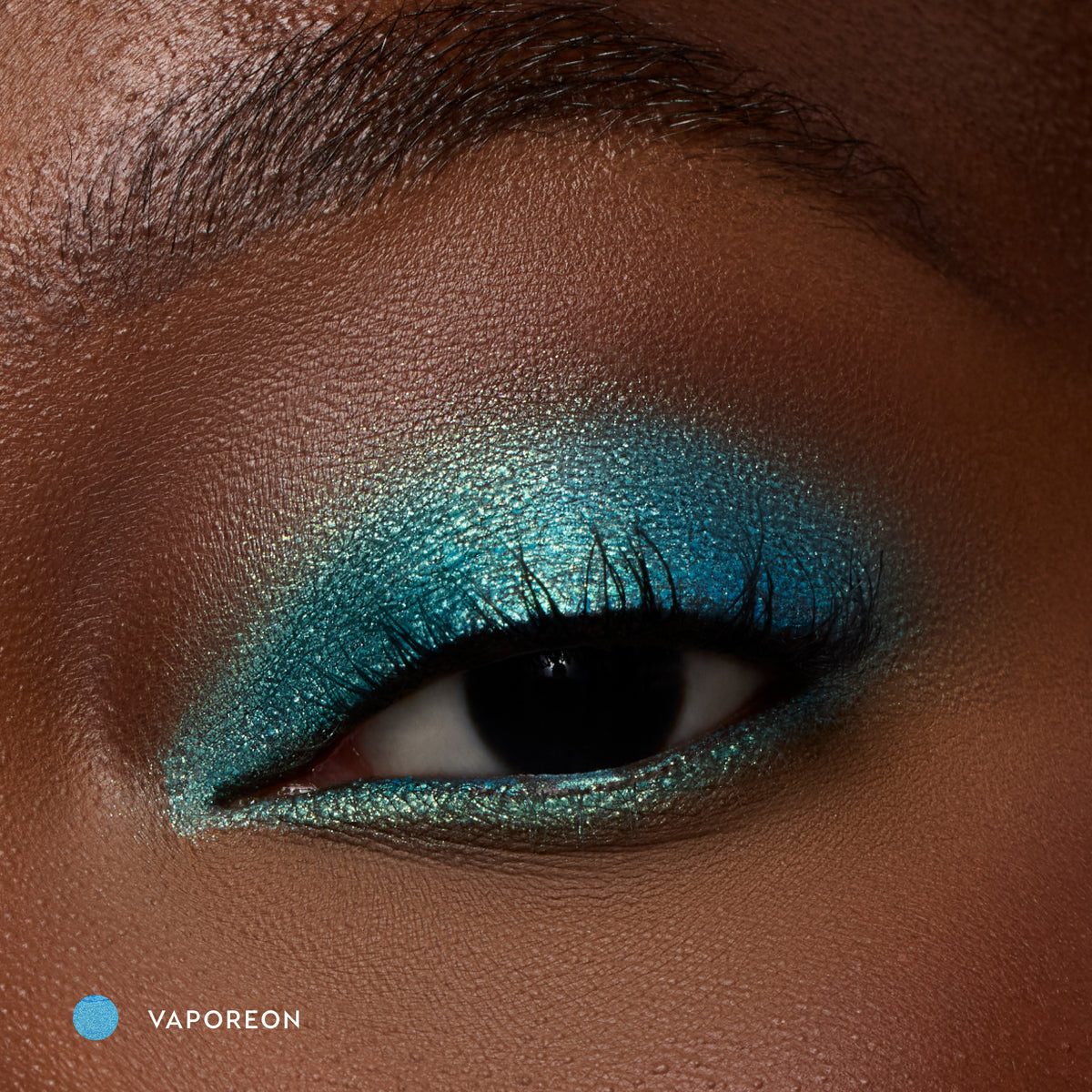 Close-up of a deep-skin eye wearing Vaporeon bright aqua shadow stick