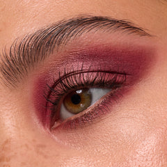 Close-up eye wears deep wine and rose shimmer shadow, lashes softly defined, showcasing ColourPop Wine and Only shadow palette with burgundy mattes and metallics blended across lid and crease for a smoky finish.