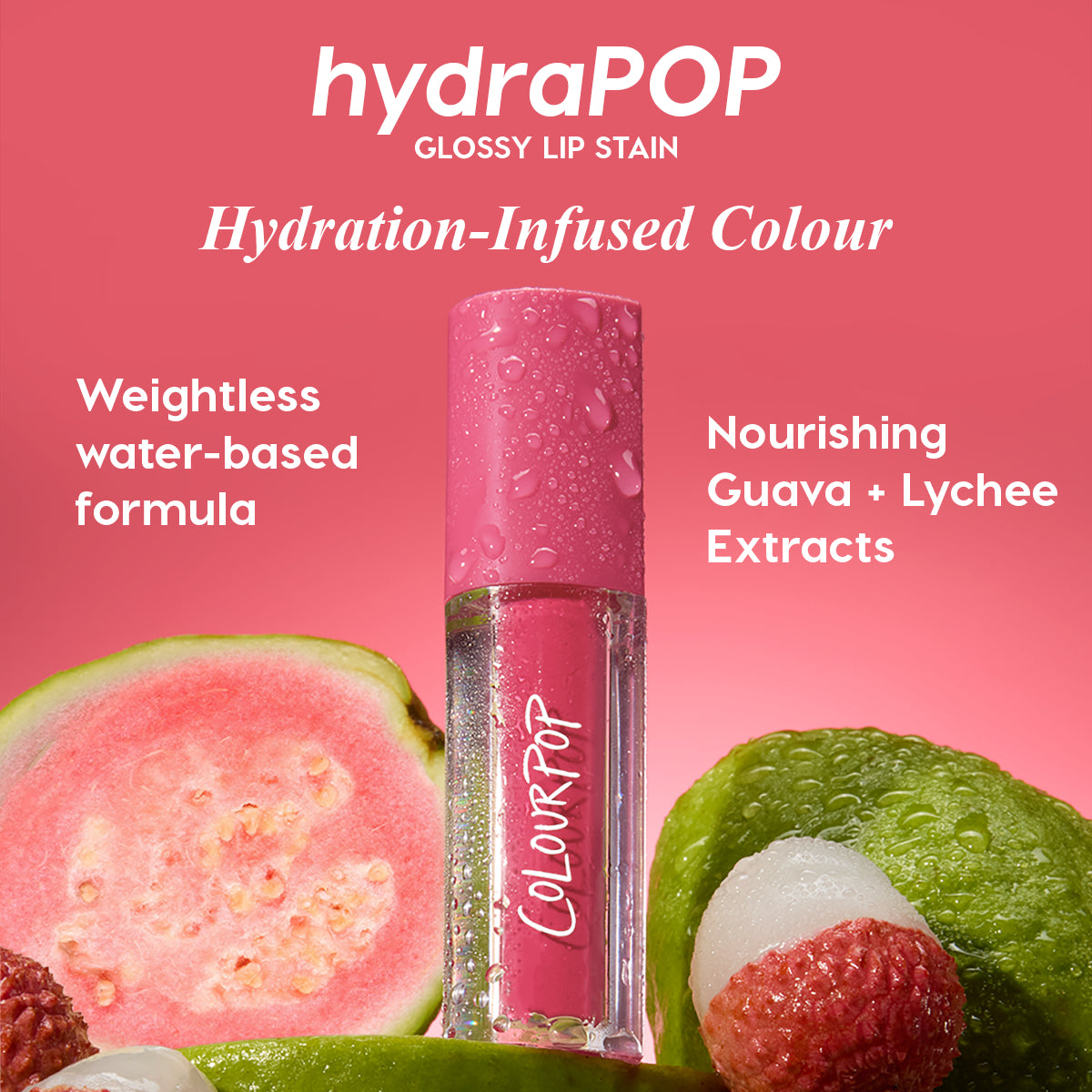 Tickle Me Pink ColourPop Lip Stain stands upright with dewy droplets on a glossy hydraPOP pink tube, surrounded by guava and lychee; a hydration-infused, weightless water-based formula with nourishing fruit extracts against a bright pink background.
