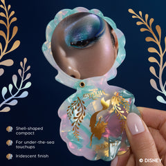 Hand holding the iridescent shell-shaped Little Mermaid compact mirror open