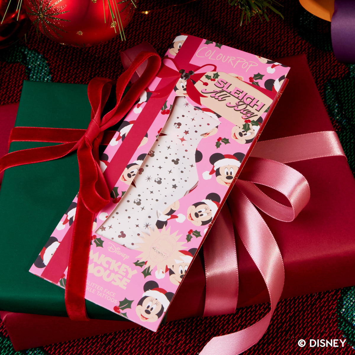 Glitter Face Freckle Tattoos box tied to a wrapped holiday gift