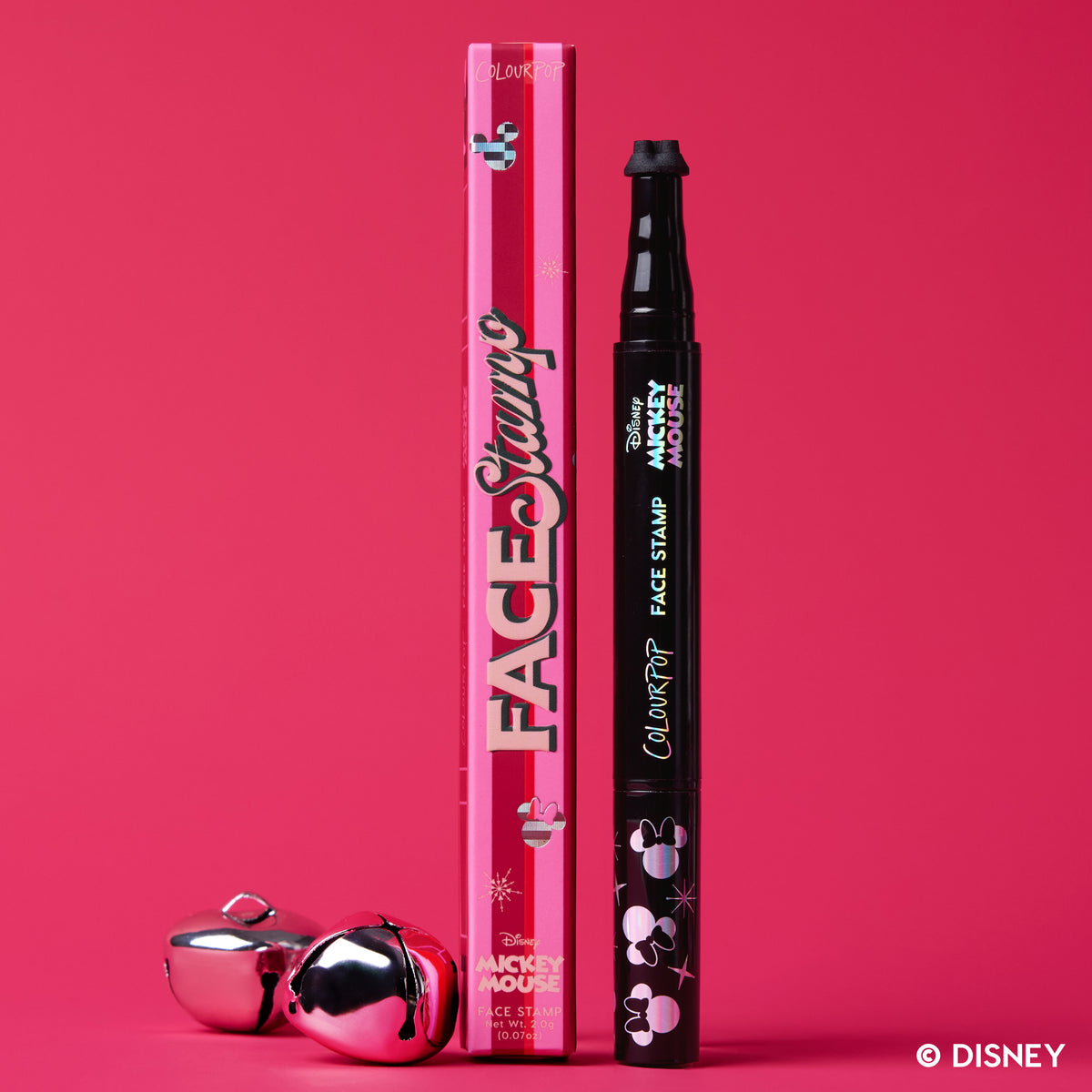 Merry Mickey Face Stamp, a pink and black dual-ended stamp, beside its Face Stamp box with silver jingle bells