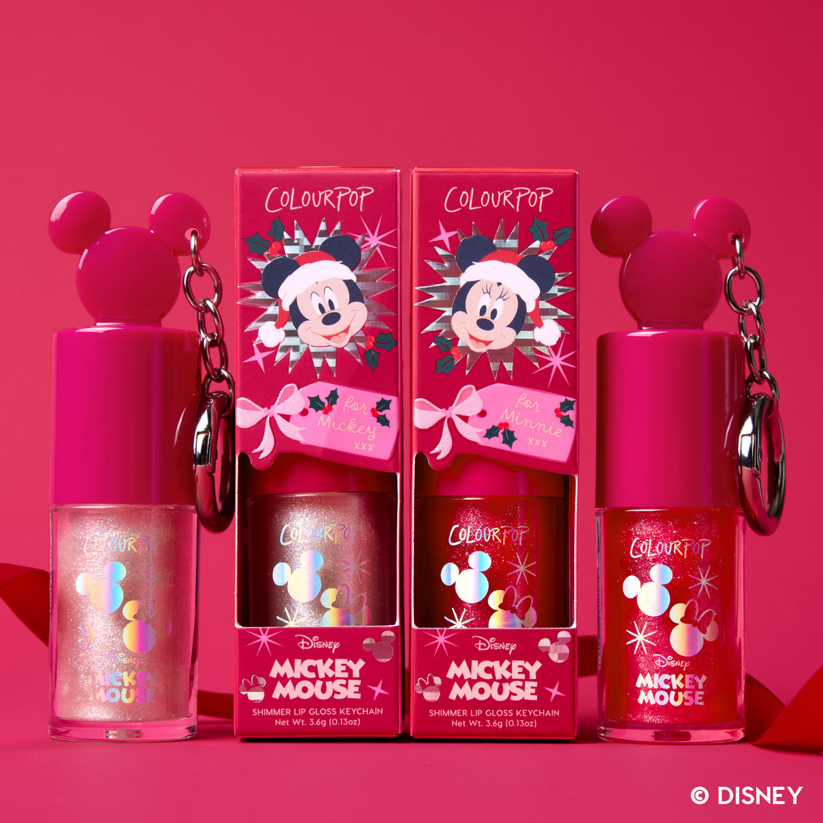 Wrapped with a Bow: two Mickey Mouse-cap Ultra Glossy Lip keychains with their holiday boxes on a red backdrop