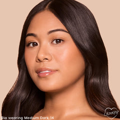 Model wearing ColourPop Pretty Fresh Tinted Foundation Balm in Medium Dark 14, showcasing a smooth, dewy, natural finish on a close-up face against a beige backdrop to demonstrate shade match and light-to-medium coverage.