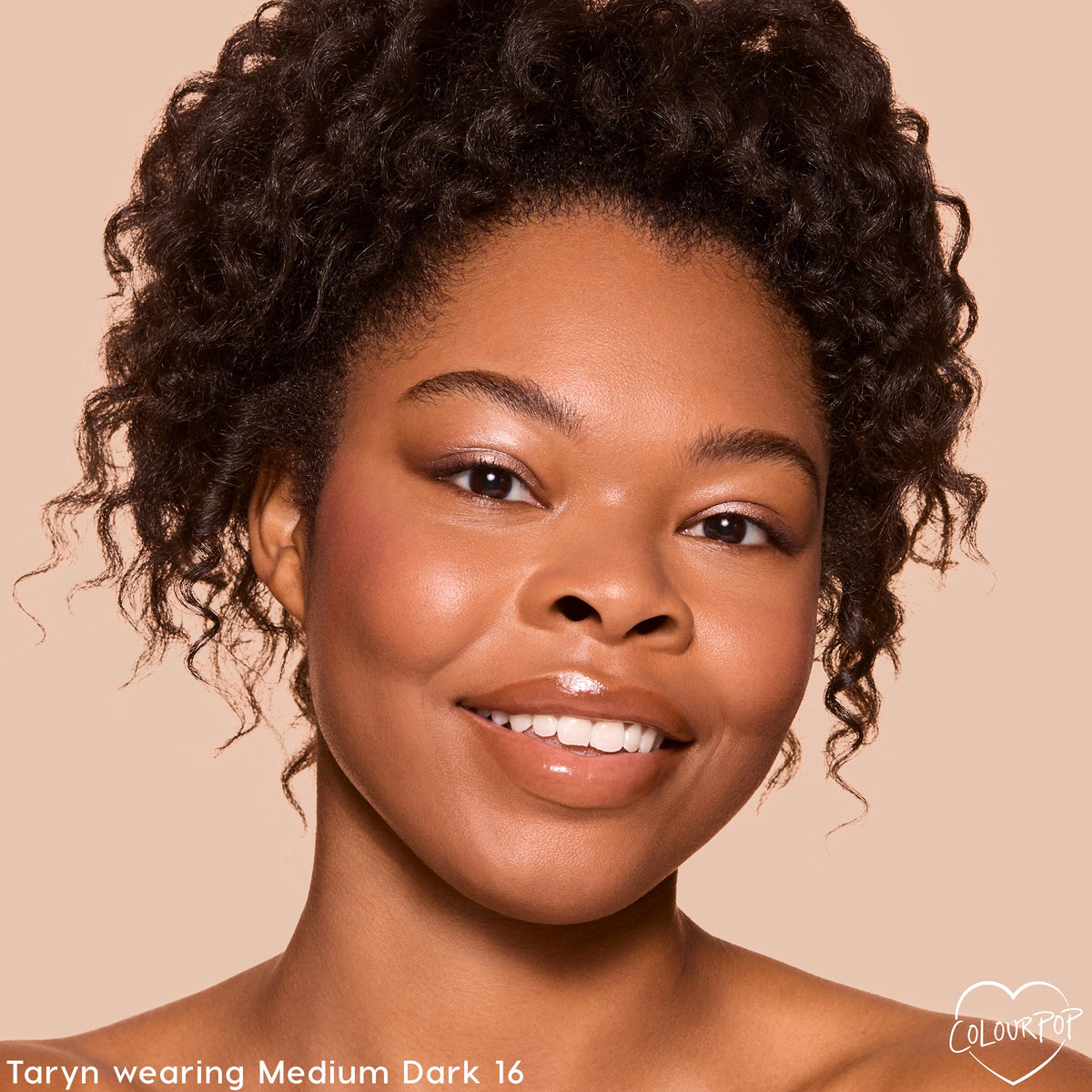Model smiles wearing ColourPop Pretty Fresh Tinted Foundation Balm in Medium Dark 16, showing smooth, dewy, medium coverage in a close-up studio shot against a beige background with soft blush and glossy lips.