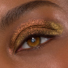 Wolf Girl ColourPop Shadow Stix creates a molten copper-to-gold duochrome on the eyelid, shimmering across the lid and crease with fine sparkle and defined lashes, macro beauty shot showing product payoff and metallic finish.