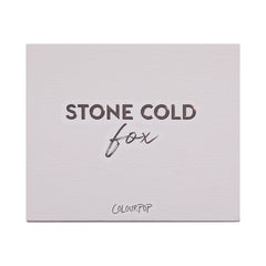 Stone Cold Fox shadow palette shown closed, featuring embossed βSTONE COLD foxβ lettering on a pale taupe faux-leather cover with ColourPop logo, studio-lit on a white background; a sleek neutral ColourPop Shadow Palette packaging shot.