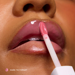 Close-up of lips being glossed over a peeled stain; model wears Super Stain in Hard to Forget