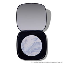 Open compact of Change Me Mega Highlighter with shimmering icy lavender and silver marbled pan set in a sleek black case with mirror, styled on a white background for the Twilight makeup collection.