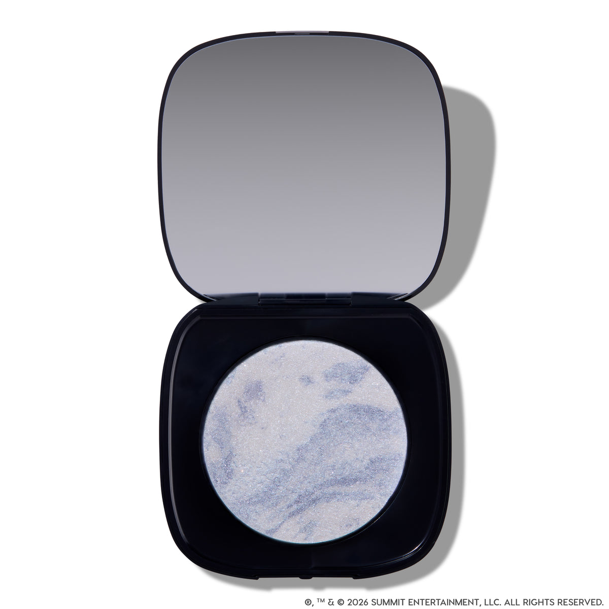 Open compact of Change Me Mega Highlighter with shimmering icy lavender and silver marbled pan set in a sleek black case with mirror, styled on a white background for the Twilight makeup collection.