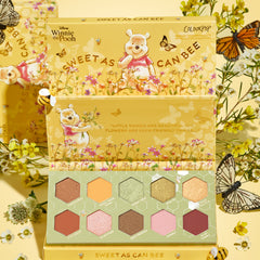 Sweet As Can Bee ColourPop Shadow Palette opens to reveal 10 hexagon pans of warm honey-toned mattes and shimmers, showcased in yellow packaging with Winnie the Pooh floral art, bees, and butterflies on a spring-themed backdrop.