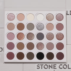 Bold + Bare ColourPop Shadow Palette Set presents an open 30-pan cool‑toned eyeshadow palette with matte and shimmer taupes, mauves, grays, silvers, plum and black, arranged in neat rows on a white tray, lid open on a light textured surface.