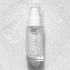 Clear pump bottle of ColourPop SOL Shimmering Dry Oil in Sterling Silver stands upright, showcasing fine silver shimmer and the SOL logo against a glittering white background.