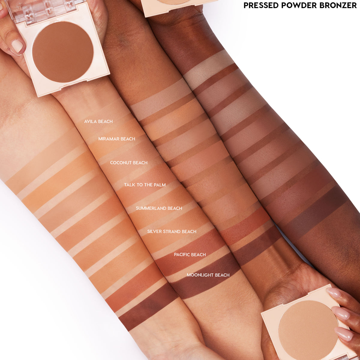 ColourPop Pressed Powder Bronzer in Silver Strand Beach swatched in clean stripes on four arms, with labeled shade lineup and two open round compacts, showing color comparison across skin tones on a white studio background.