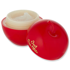 Just One Bite ColourPop Lip Scrub opens to reveal a creamy sugar scrub in an apple-shaped red jar with gold “Just One Bite” lettering, cap set beside on a white background; Snow White lip scrub product packaging close-up.