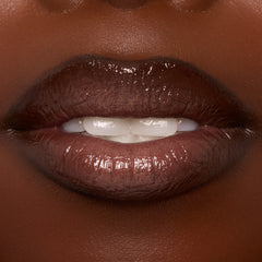 Lips wearing ColourPop Ultra Glossy Lip in Coffee Break, showing a rich coffee-brown, high-shine finish in an extreme close-up of a slightly parted mouth, highlighting smooth, glassy coverage and a plush, glossy nude look.