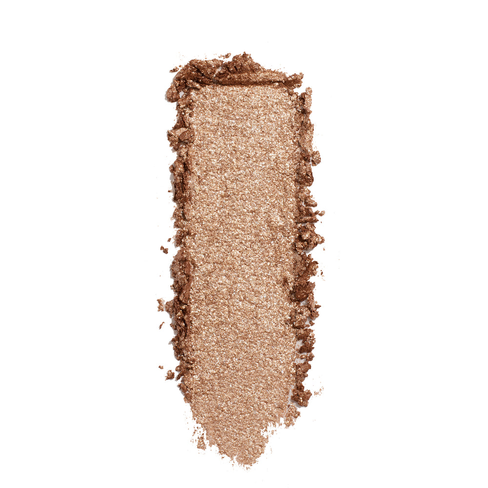 Shimmery champagne-beige eyeshadow swatch streaks vertically, showing the creamy metallic finish of ColourPop A Little Quarky Super Shock Shadow against a clean white background.