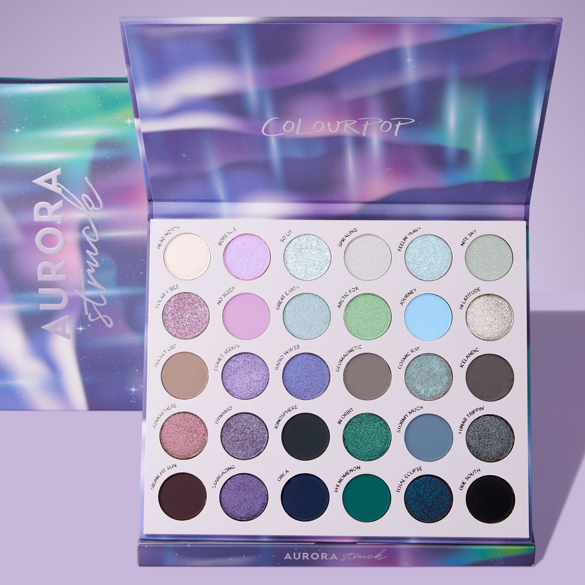 Aurora Struck 30-pan eyeshadow palette open beside its Northern Lights-print packaging