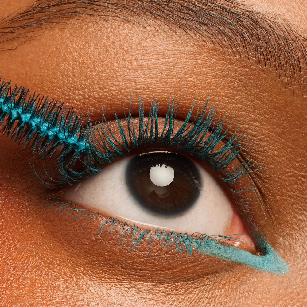 Teal-coated lashes as a wand applies ColourPop BFF Mascara in Swell Season, a bright turquoise BFF Mascara that defines upper and lower lashes with matching inner-corner liner, shown in an extreme close-up eye for pigment and separation.