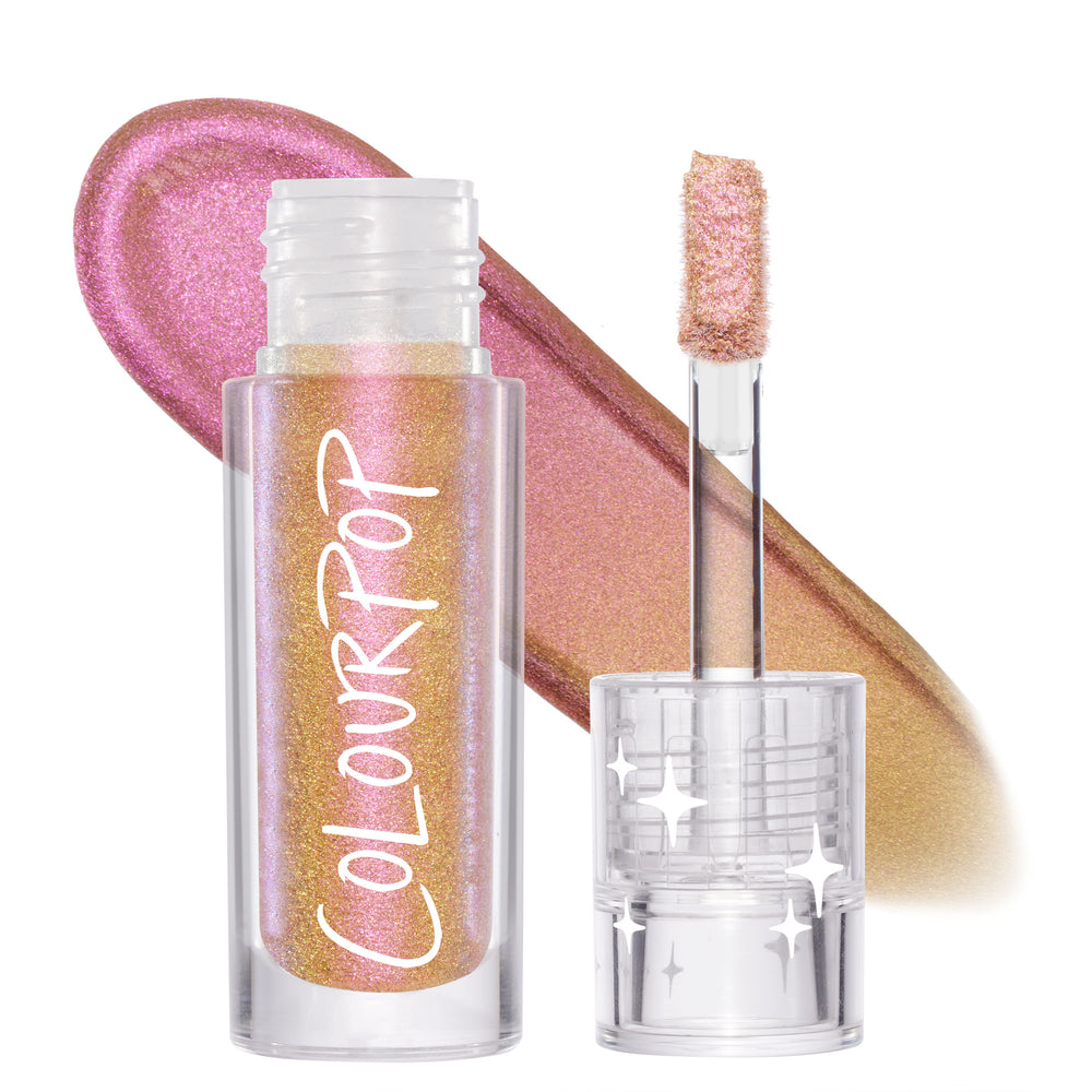 Bliss ColourPop Chrome Liquid Shadow shows a multi-chrome shift from rose pink to gold to lavender; clear tube with ColourPop logo and star-etched cap stands open, doe-foot applicator raised, with a shimmering swatch behind on a white studio background.