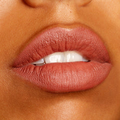 Lips wear Brink, a ColourPop Lippie Pencil, defining and filling the mouth in a warm rosy terracotta nude with a soft matte finish, shown in a close-up beauty swatch to highlight the creamy, long-wearing precision of this lip liner.