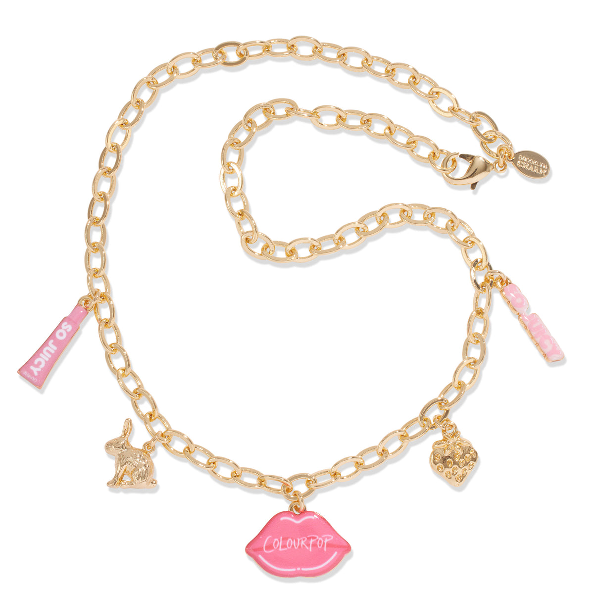 Brooklyn Charm x ColourPop Necklace draped on a white background, featuring a gold-tone chain with lobster clasp and enamel charms: pink lips reading 'ColourPop', So Juicy tube, bunny, strawberry, and pink bubble-letter bar.