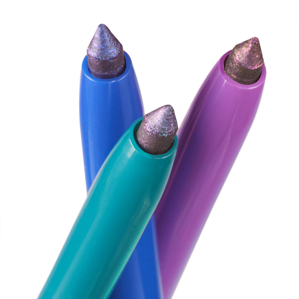 Three multichrome gel eyeliner tips gleam from teal, cobalt, and purple twist-up barrels, showcasing ColourPop Chrome Crème Gel Liner in Chrome Dreams with an iridescent lavender-to-teal shift, photographed close-up on a white studio background.
