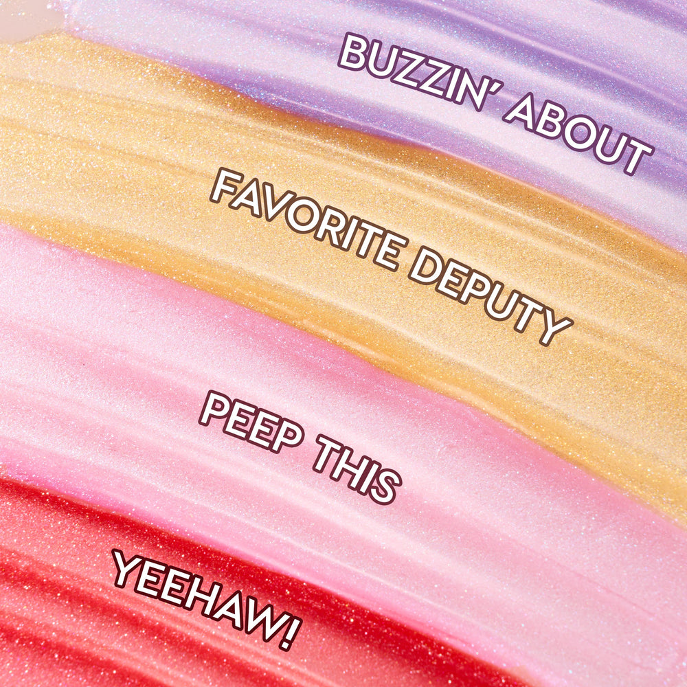 Four shimmering swatches display Squad Dreams ColourPop Ultra Glossy Lip - lavender Buzzin’ About, golden Favorite Deputy, baby‑pink Peep This, and cherry red Yeehaw! - swept in wide bands to showcase sparkle and high‑shine finish.