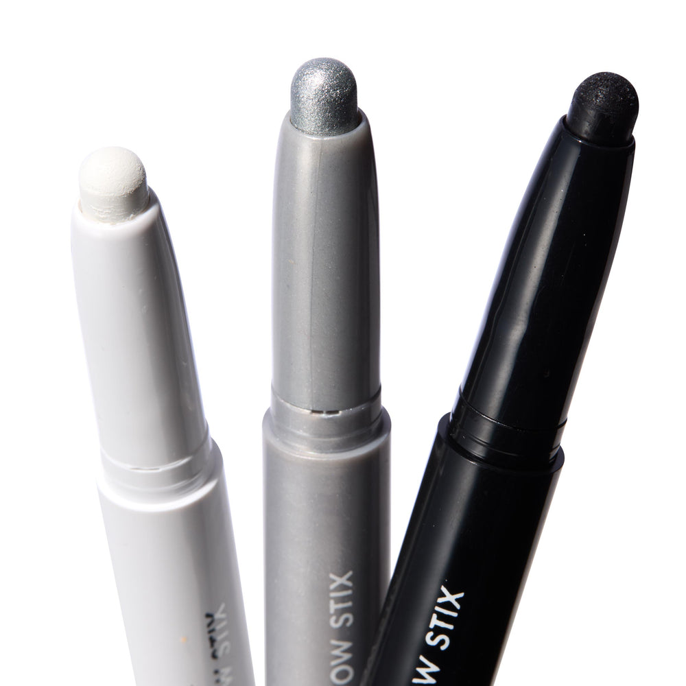 Totally Wicked ColourPop Shadow Stix trio showing exposed tips - matte white, metallic silver, and black shimmer - standing upright in white, gray, and black twist-up tubes on a bright white background.
