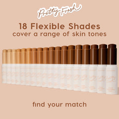 ColourPop Pretty Fresh Tinted Foundation Balm sticks lined up in a gradient of 18 flexible shades - from fair to deep - on a blush-beige backdrop, showcasing inclusive coverage; white tubes with peach script, including shades like Medium 12.