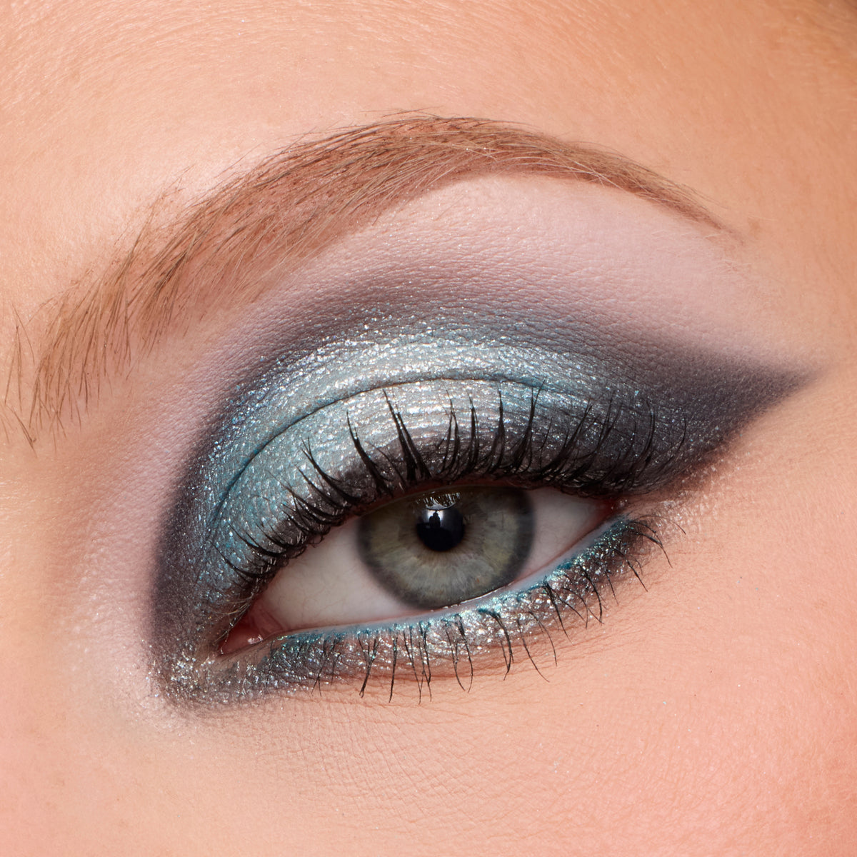 Close-up of a fair-skin eye wearing a smoky icy blue and silver wing from the Eeveelution palette