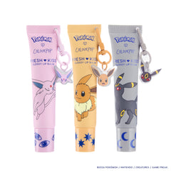 Espeon lilac, Eevee tan and Umbreon grey Fresh Kiss Glossy Lip Balm tubes, each with its Pokémon keychain charm