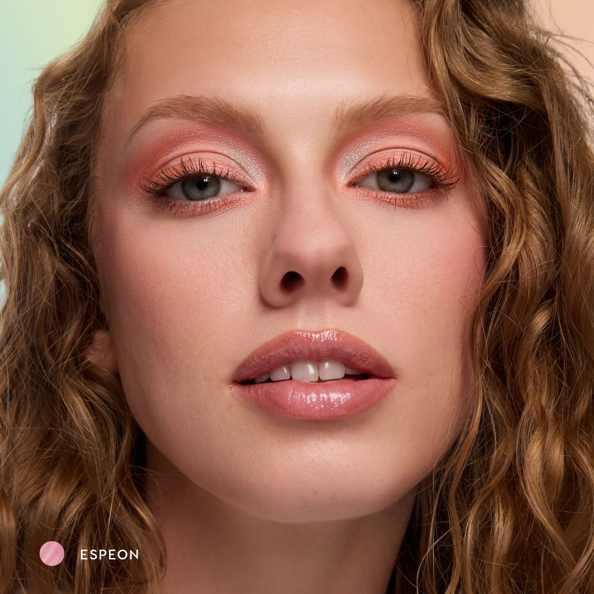 Model with fair skin wearing Espeon sheer lilac glossy lip balm with peach eyeshadow