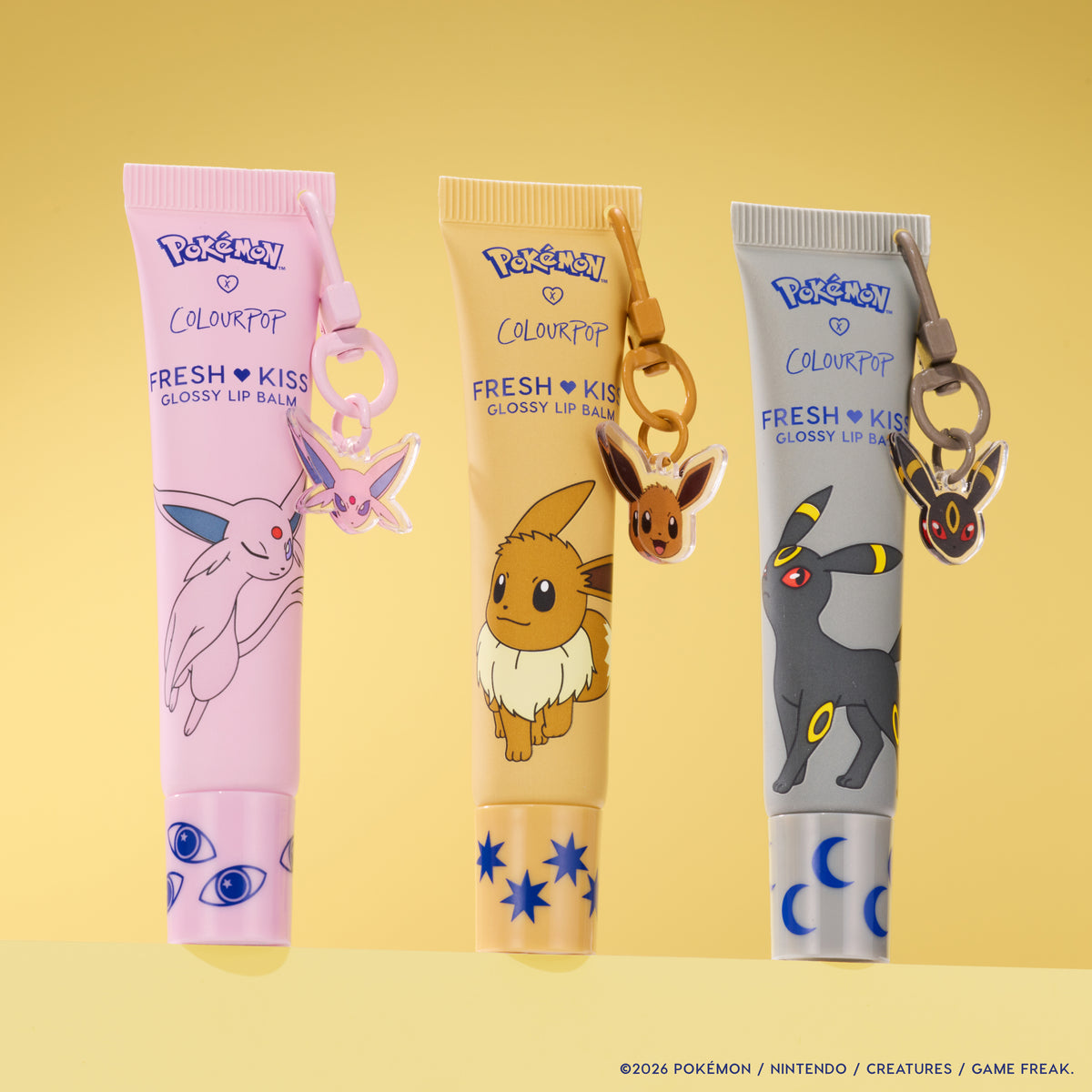 Daybreak and Moonlight trio: Espeon, Eevee and Umbreon Fresh Kiss Glossy Lip Balm tubes with character keychain charms