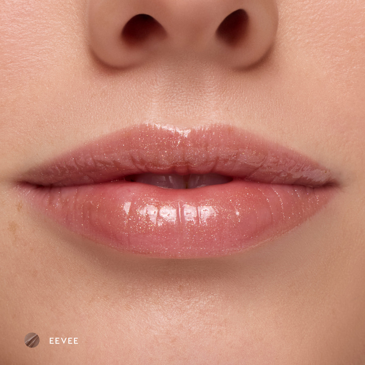 Close-up of fair-tone lips wearing Eevee sheer nude glossy lip balm
