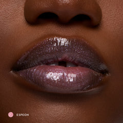 Close-up of deep-tone lips wearing Espeon sheer lilac glossy lip balm with sparkle