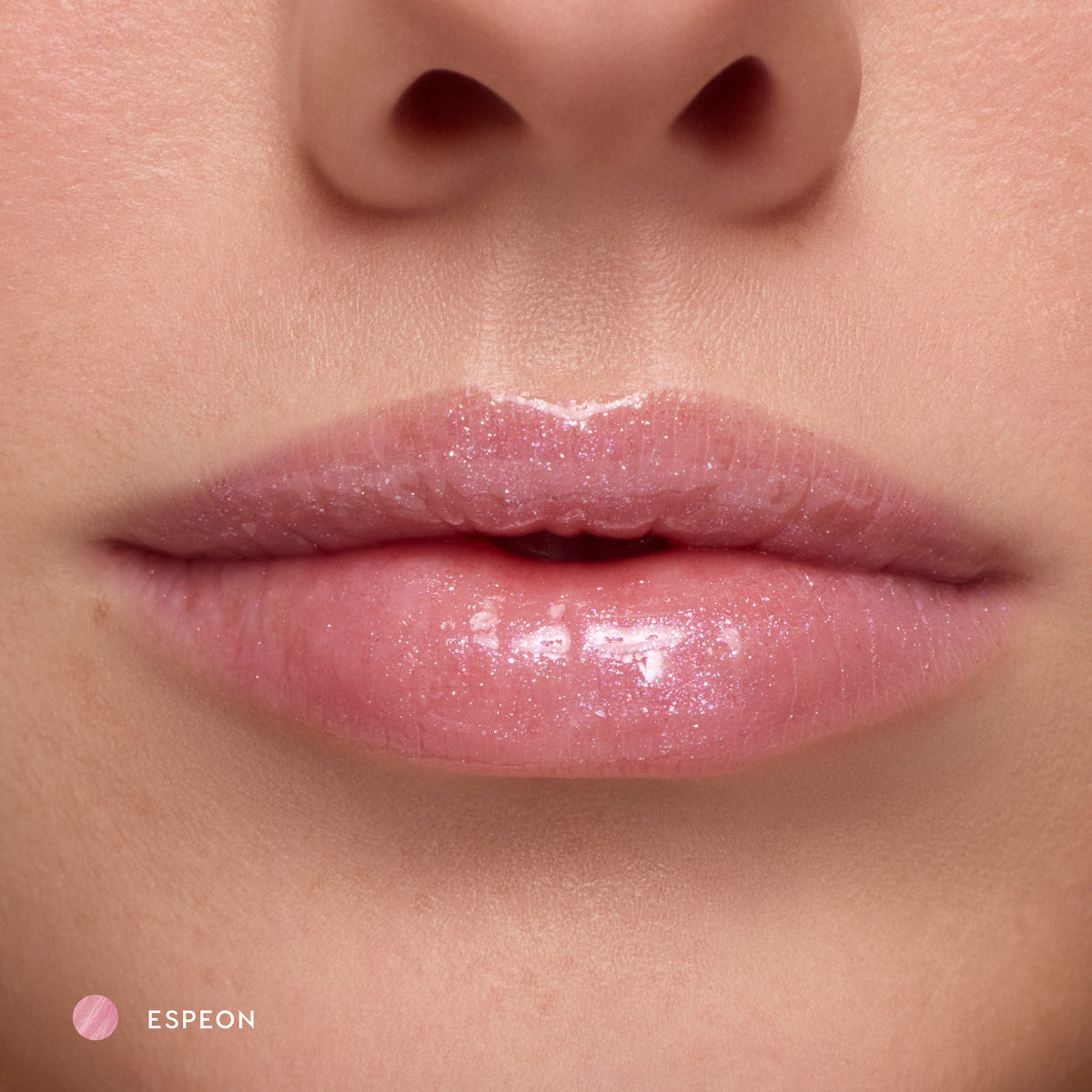 Close-up of fair-tone lips wearing Espeon sheer lilac glossy lip balm