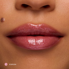 Close-up of medium-tone lips wearing Espeon sheer lilac glossy lip balm