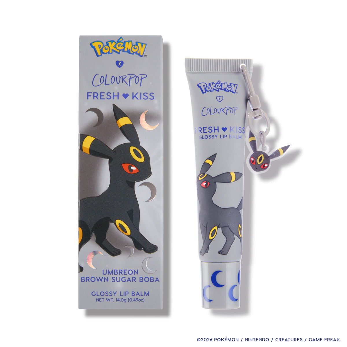 Umbreon Fresh Kiss Glossy Lip Balm tube and box with a dangling Umbreon charm keychain
