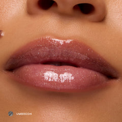 Close-up of medium-tone lips wearing Umbreon sheer black glossy lip balm