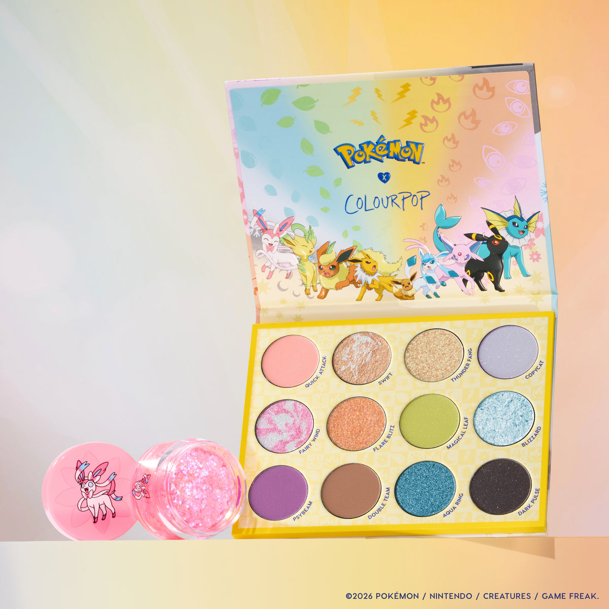 Touch of Sparkle set: Eeveelution Eyeshadow Palette open with a jar of Sylveon Glitterally Obsessed glitter