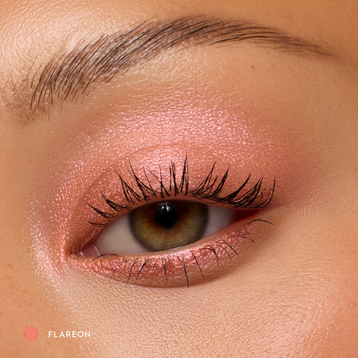 Close-up of a medium-skin eye wearing Flareon tangerine shadow stick