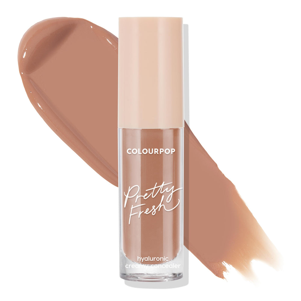 ColourPop Pretty Fresh Creamy Concealer in Dark 153 C stands upright with a beige cap, showcasing its hyaluronic formula and warm deep tan shade, as two large swatches streak behind on a white background.