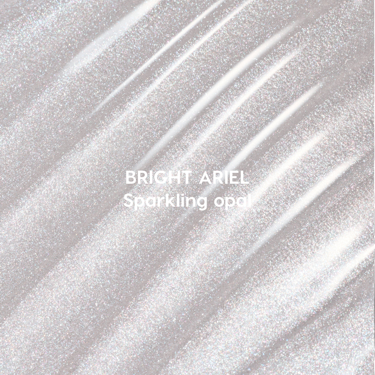 Bright Ariel Ultra Glossy Lip swatch showing shimmering sparkling opal gloss in wavy strokes against a light background, highlighting high-shine Disney Princess inspired lip color texture for US makeup lovers.