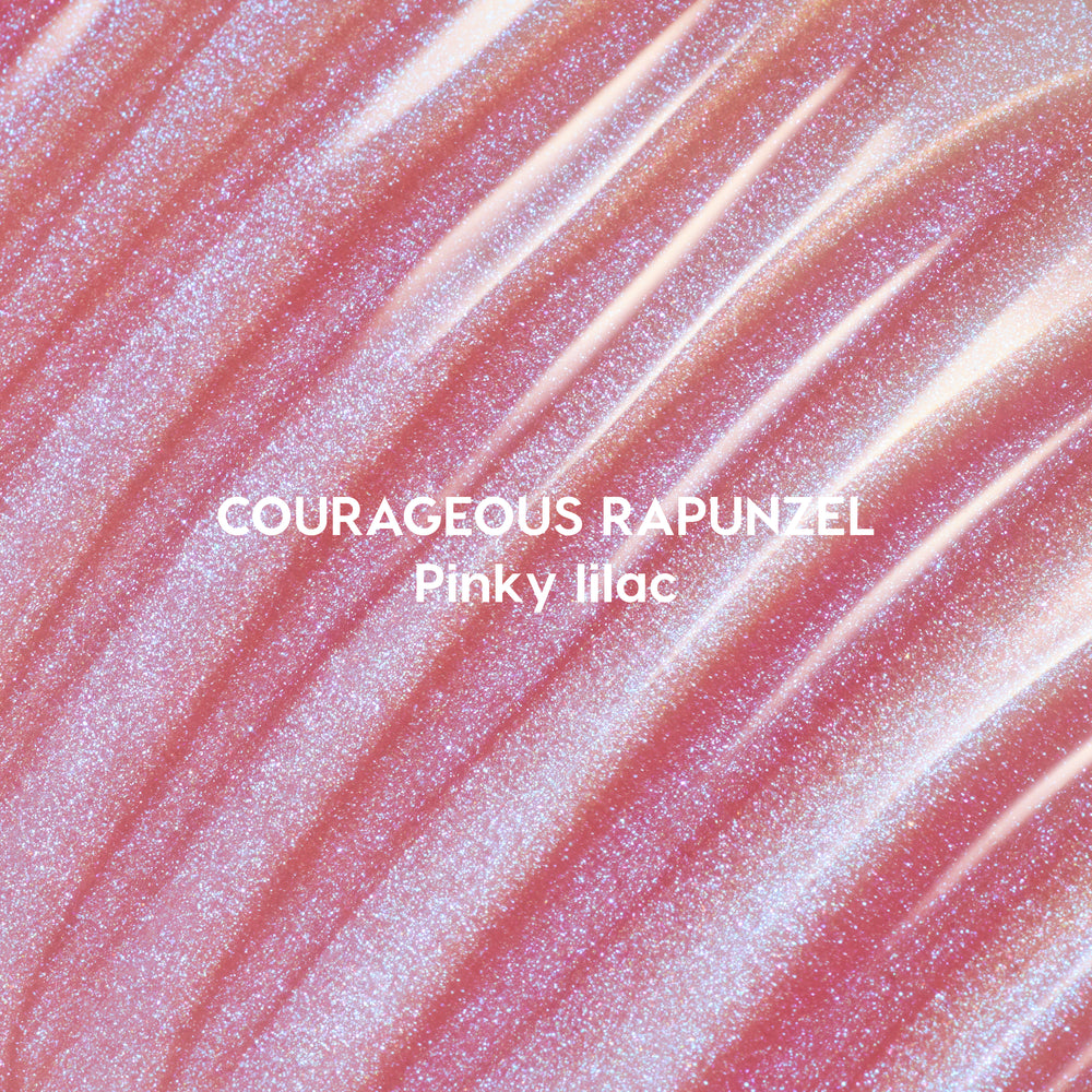 Courageous Rapunzel Ultra Glossy Lip swatch showing shimmery pinky lilac Disney Princess lip gloss with high-shine, iridescent glitter streaks spread in smooth, reflective waves on a close-up background.