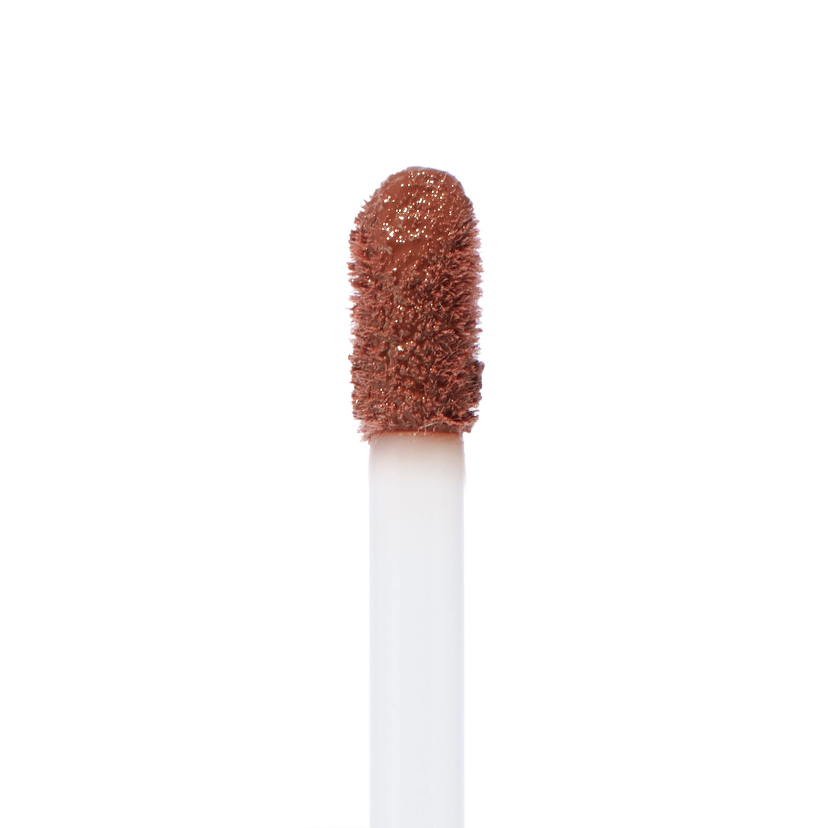 Doe-foot applicator swiped with Espresso Martini, a warm coffee-brown ColourPop Ultra Blotted Lip, showing diffused pigment and plush texture in a macro close-up on a white background.