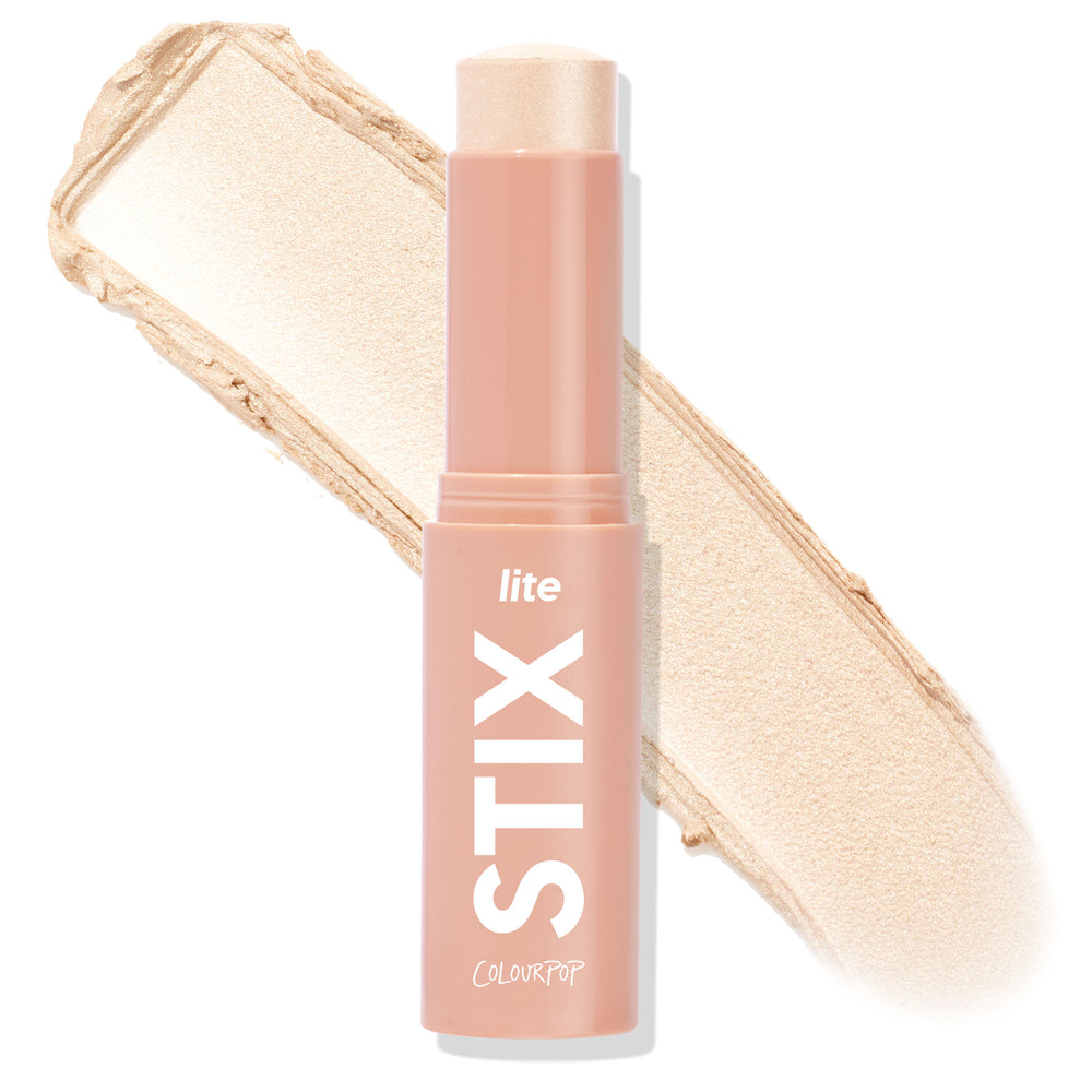 Glazey ColourPop Lite Stix highlighter stands uncapped, showing a champagne‑pearl cream stick with a wide swatch behind, housed in a blush‑pink tube labeled STIX and ColourPop against a white background.